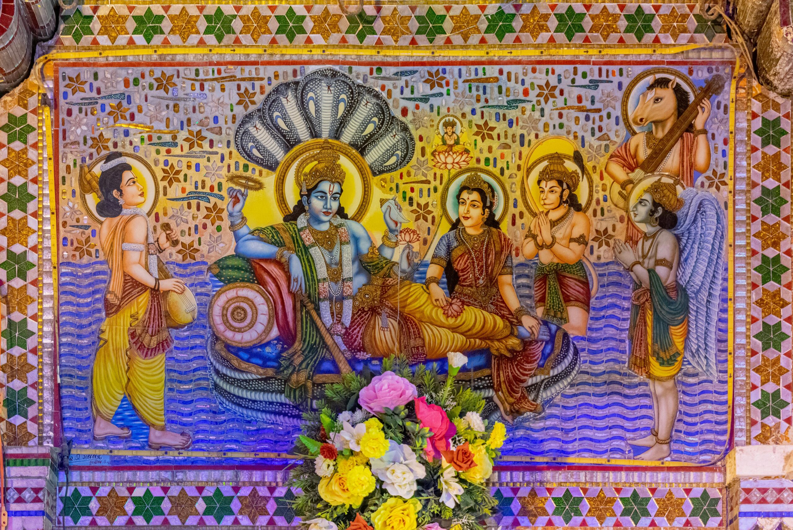 Vibrant mural depicting Hindu deities in Palanpur, India, showcasing religious art and spirituality.